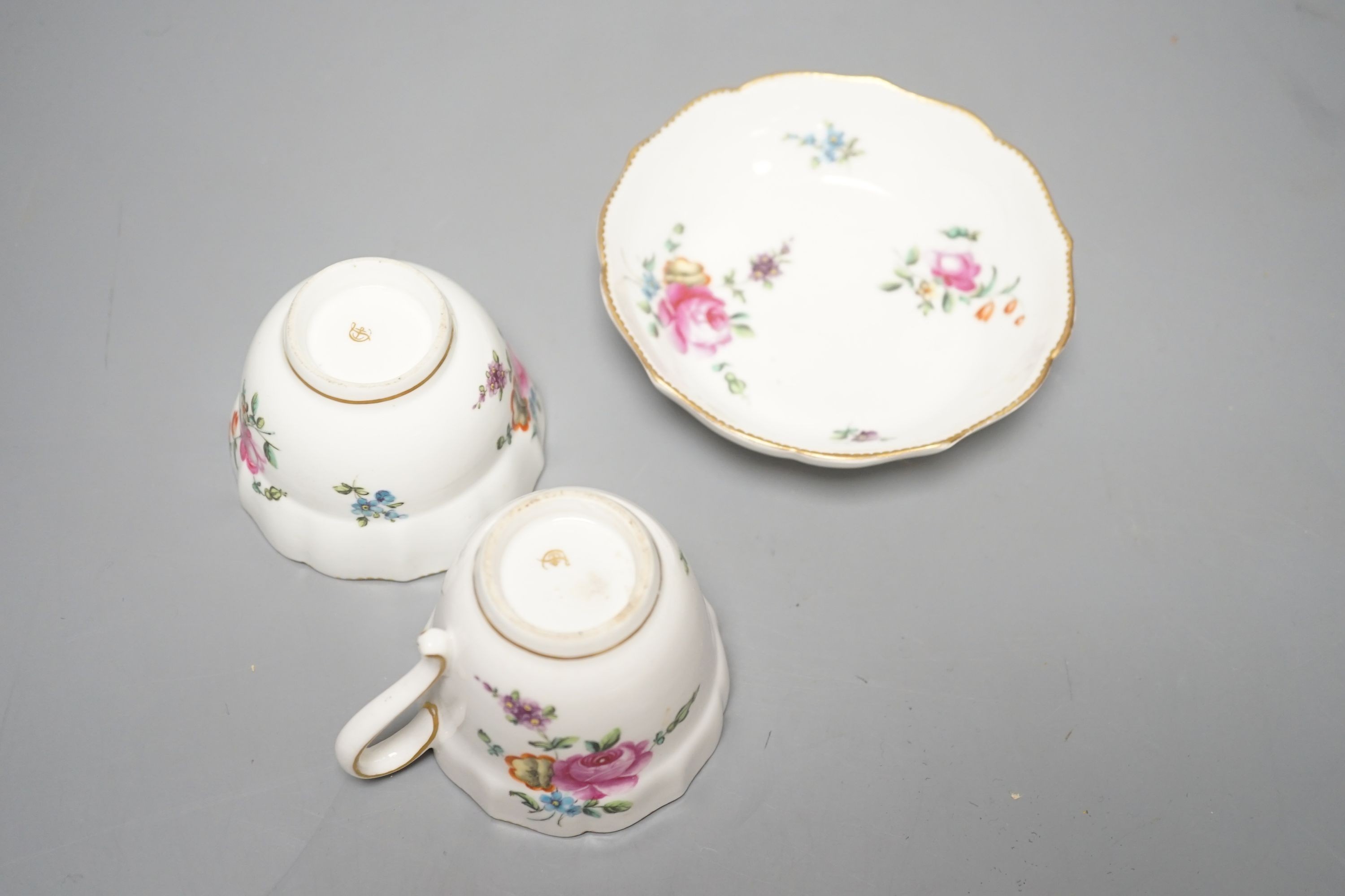 A Chelsea-Derby coffee cup, tea bowl and saucer painted with sprays and sprigs of flowers, c.1775, diameter 12cm